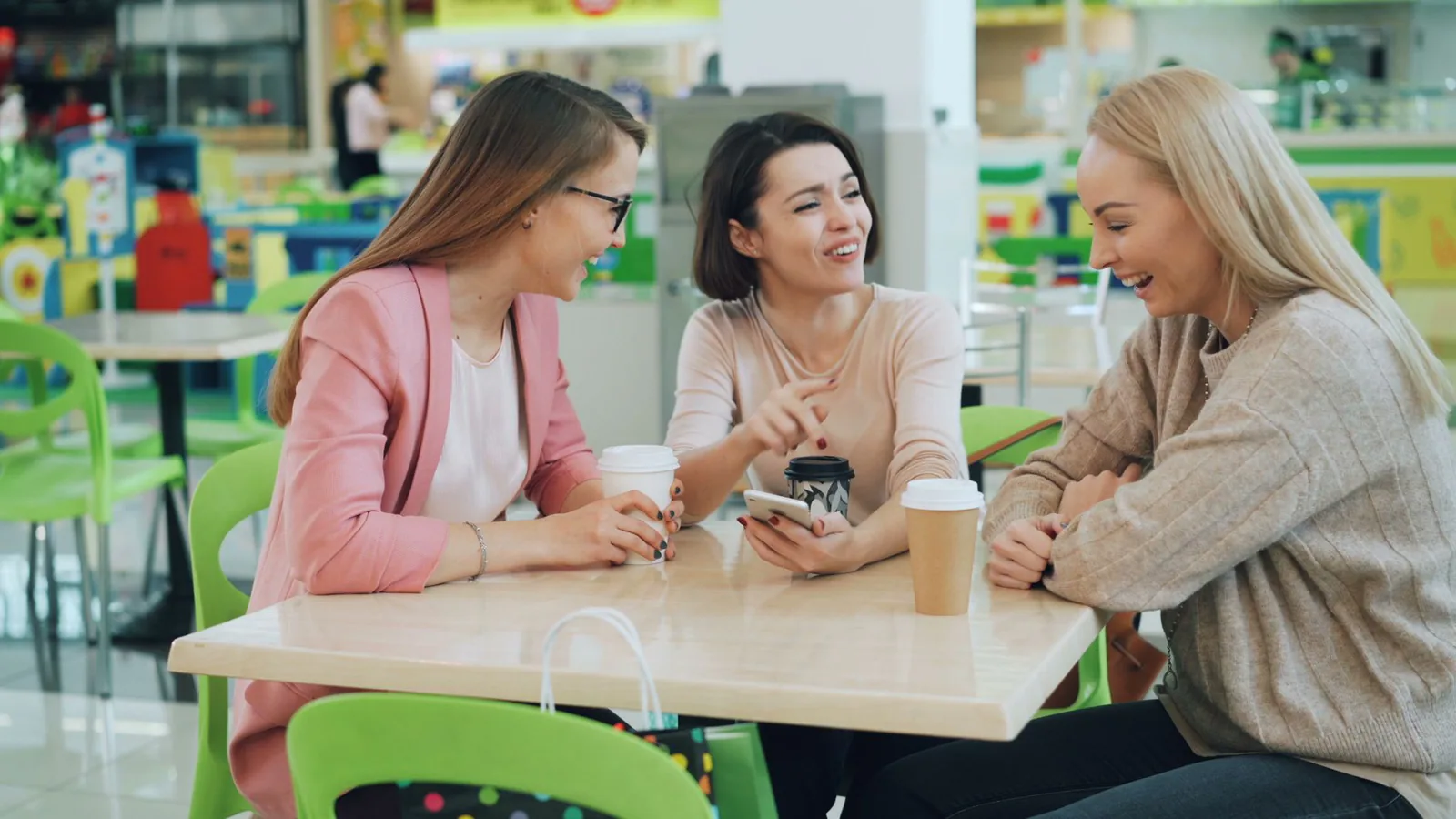 Friends laughing over coffee