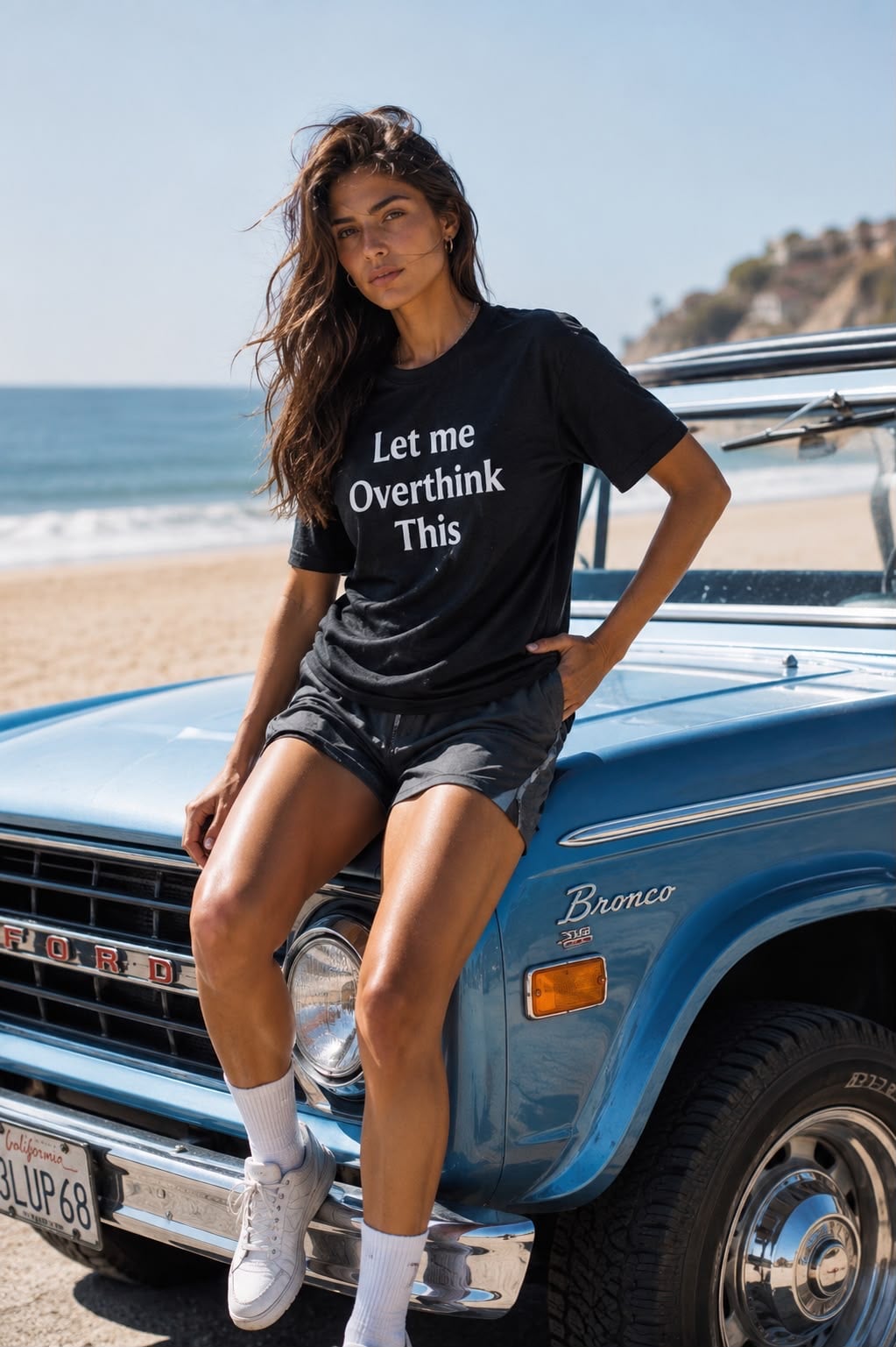 Woman wearing a Feel Good Story shirt beside a vintage beach car